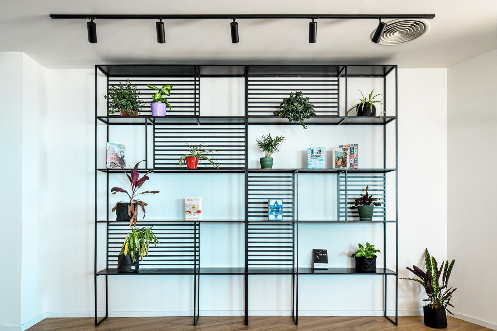Black metal shelving with plants on a white wall, Taiwan Trade Center in Pisgat Tower, Tel Aviv – Chen Shadmi, Shadmi Design