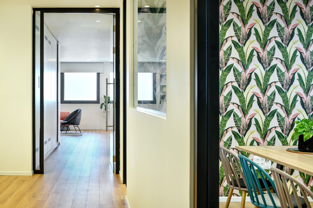 Glass doorway beside the wallpaper wall