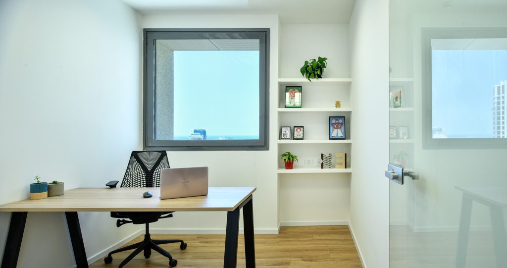 Private office with a wooden desk and built-in shelves